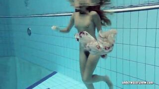 Lucy strips underwater and shows hairy vagina