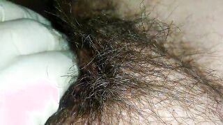 Hairy milf pampers her pussy with latex gloves